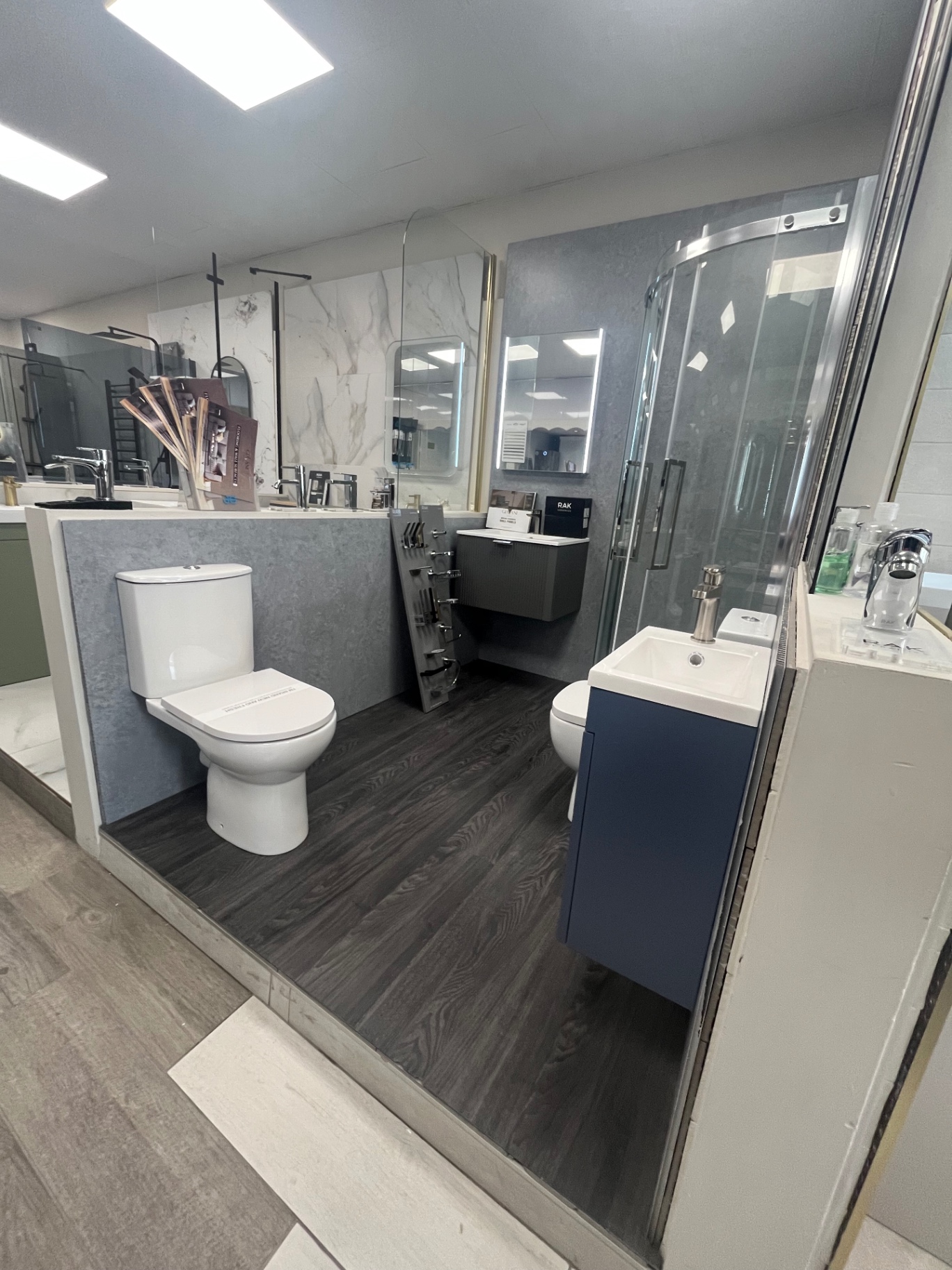 Compact en-suite with quadrant shower and navy vanity