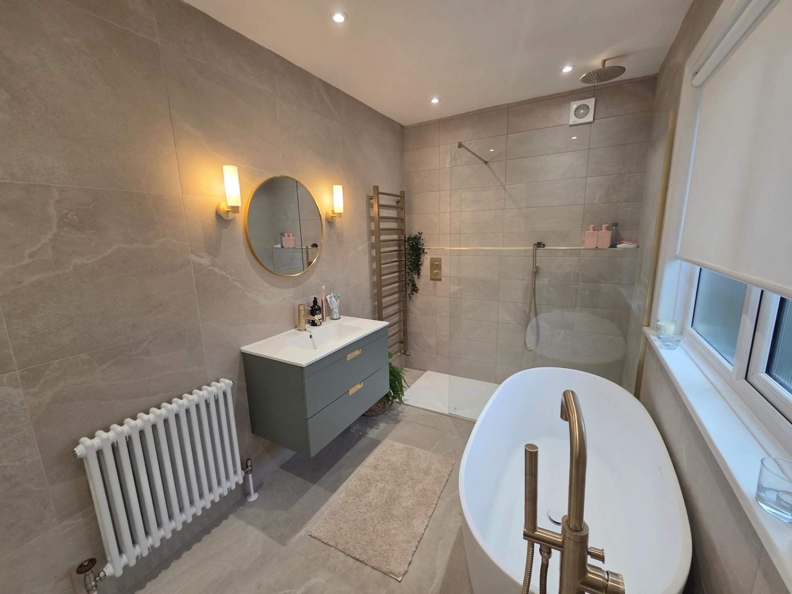 Brushed brass family bathroom with freestanding tub
