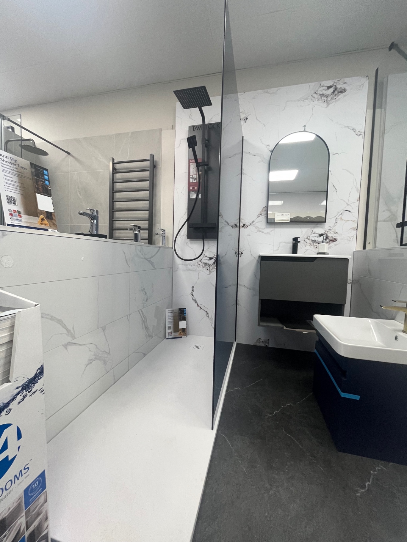 Marble-panelled shower with graphite vanity