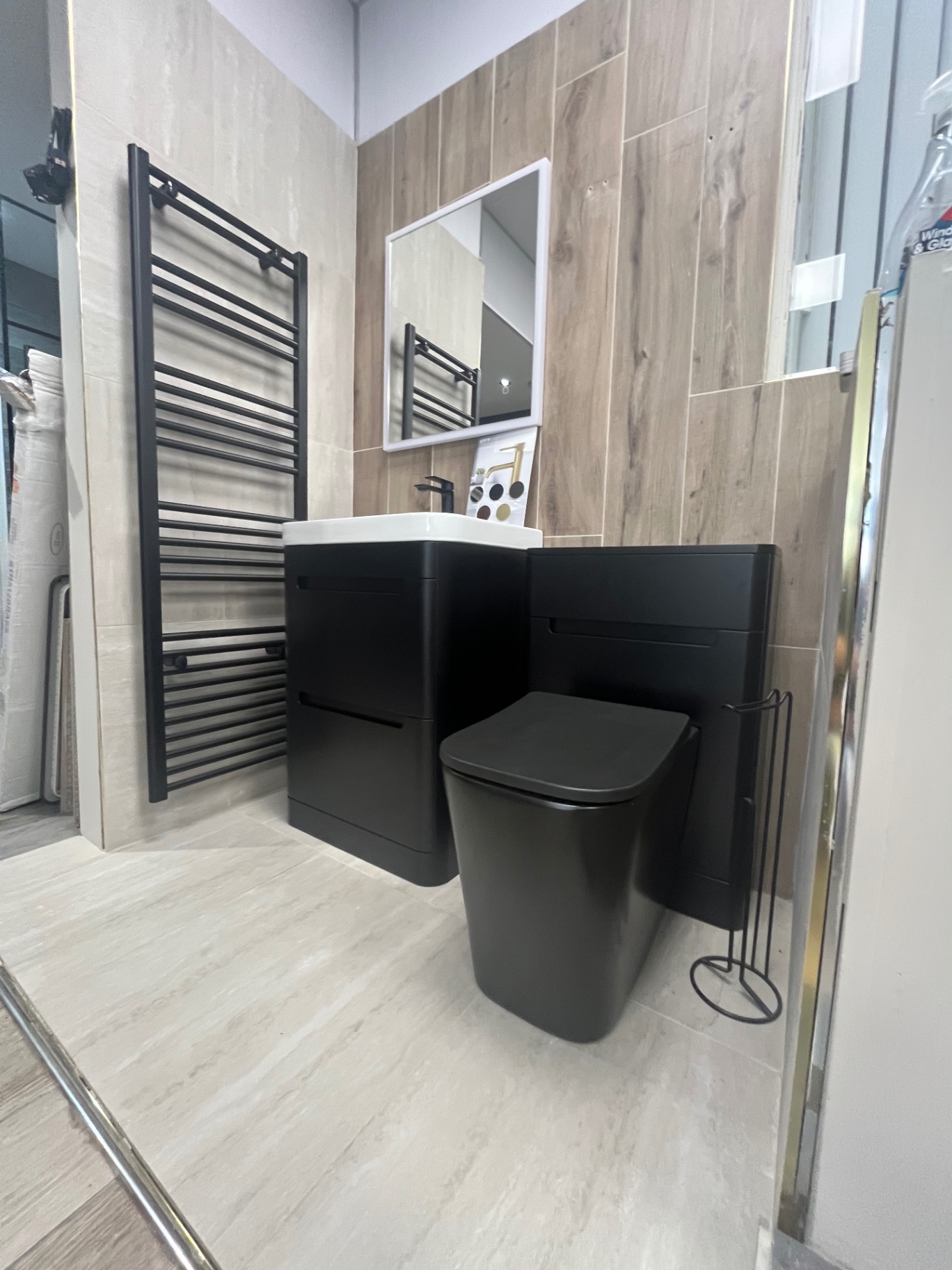 Matt black suite with oak-effect walls